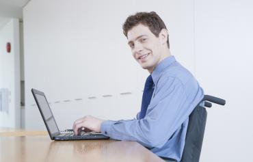 Man in wheelchair at computer